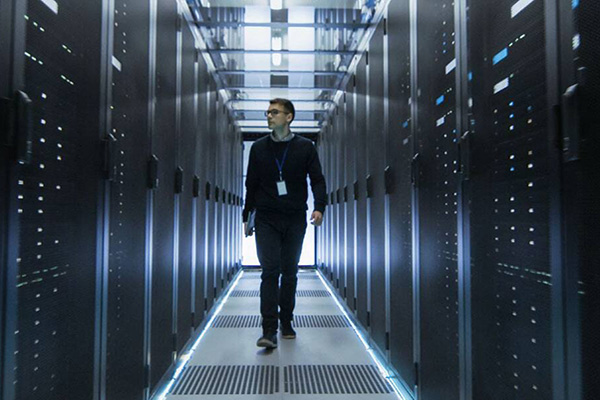 Man walking inside a data center