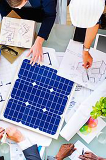 Group of engineers having a discussion over a blueprint