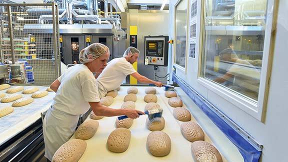 Group of bakers baking in a bakery
