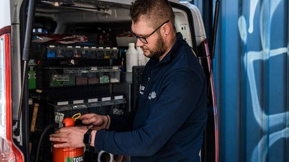 Firefighter inspecting a fire extinguisher