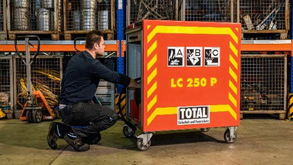 Firefighter inspecting an extinguishing container