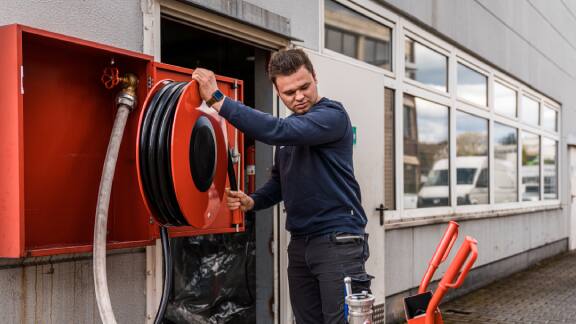 Firefighter unwinding a water hose