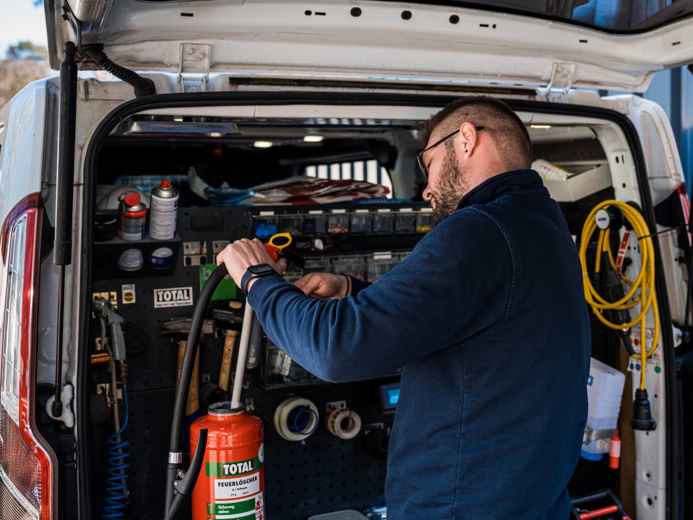 Firefighter inspecting a fire extinguisher