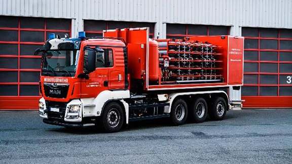 A truck carrying rows of fire extinguishers