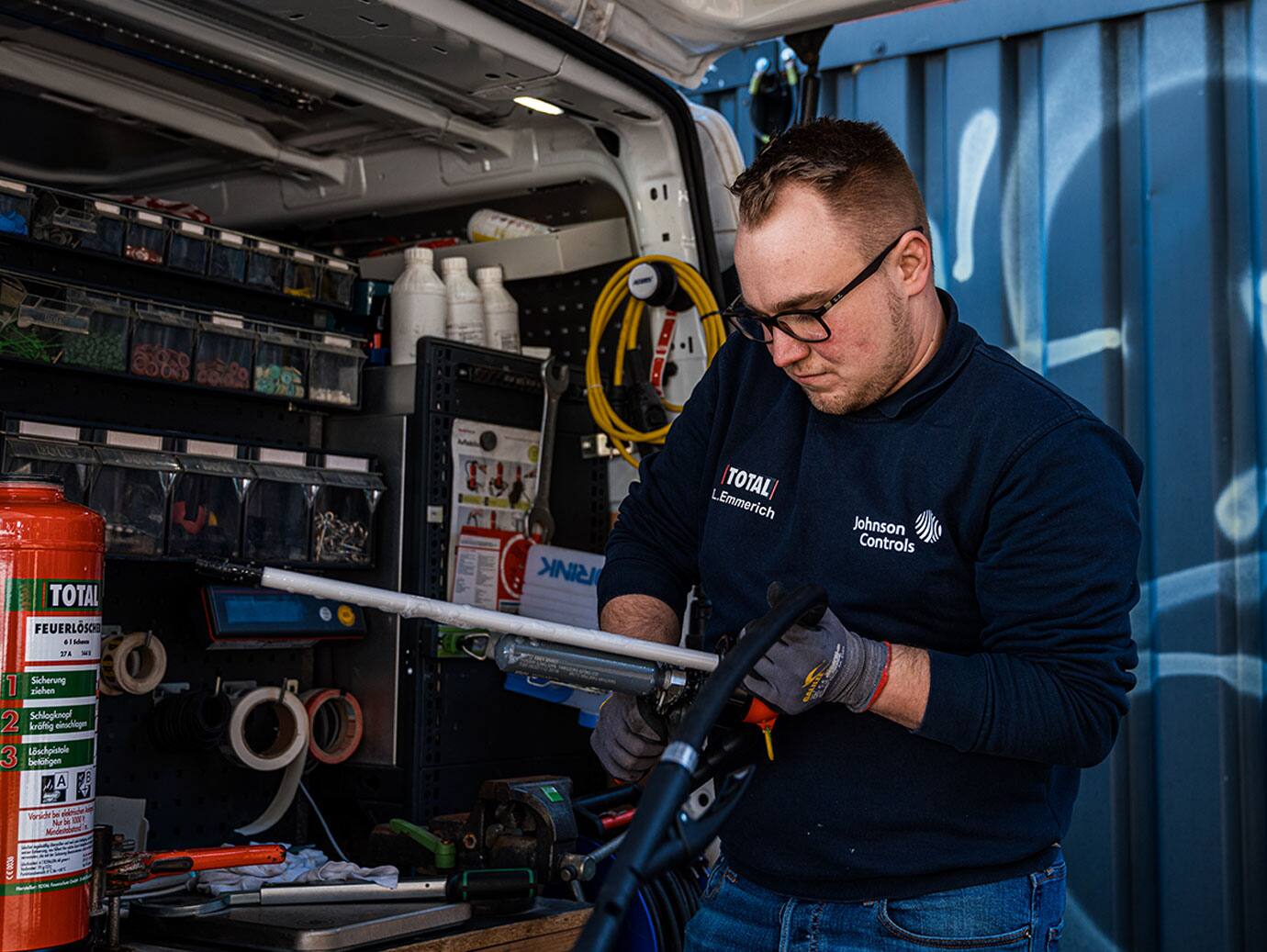 Firefighter inspecting a fire extinguisher