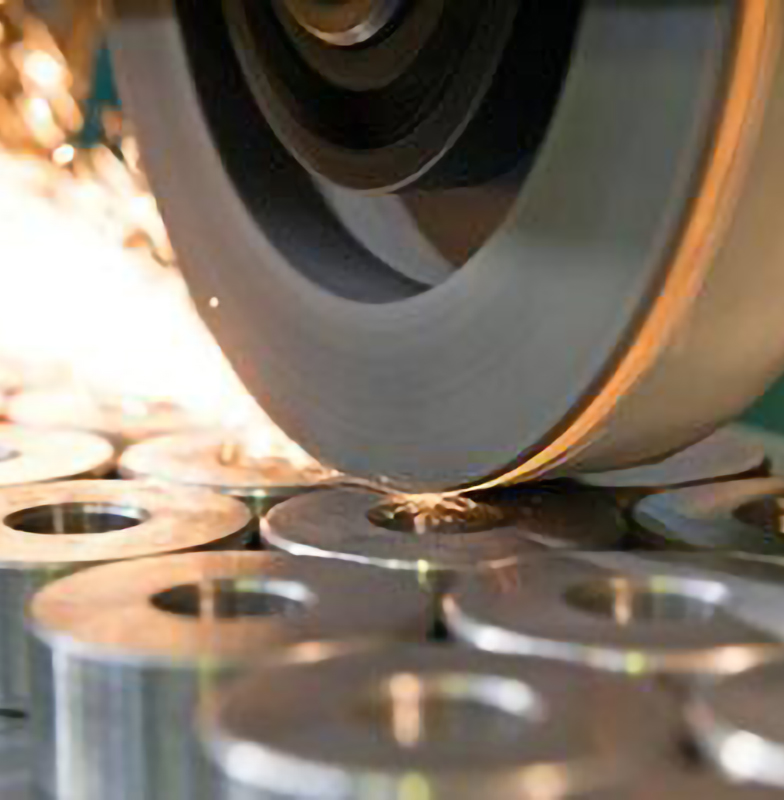 Sparks igniting from a polishing machine being used on screws