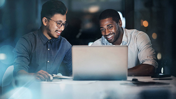 Two colleagues having a hearty conversation in office