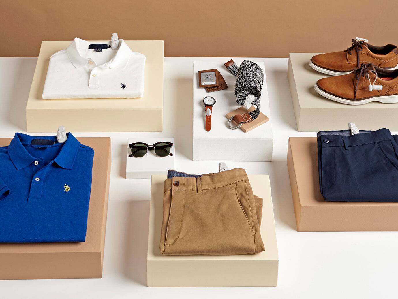 Men's clothes and accessories neatly arranged on a table