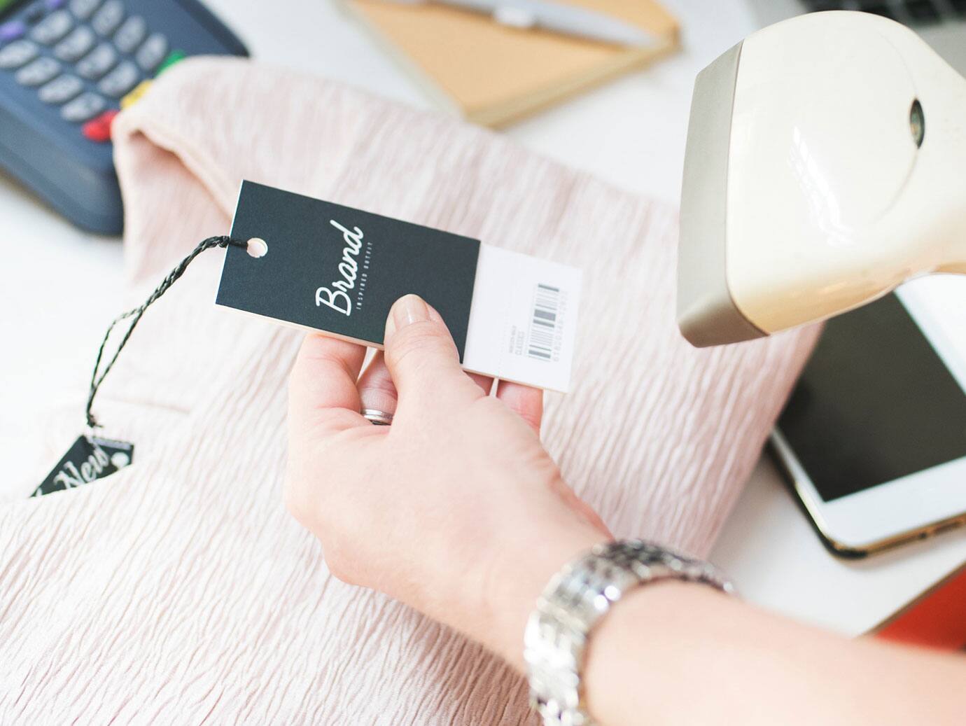 A price tag on a pink blouse being scanned
