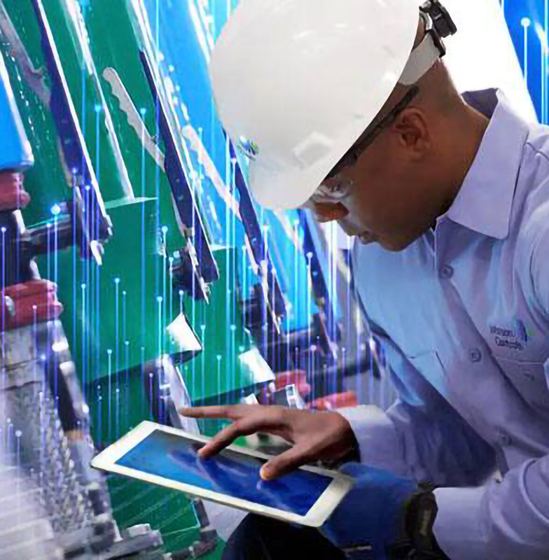 Employee from Johnson Control sitting and looking at his tab near the hardware unit section overlaid with graphics of transmission nodes
