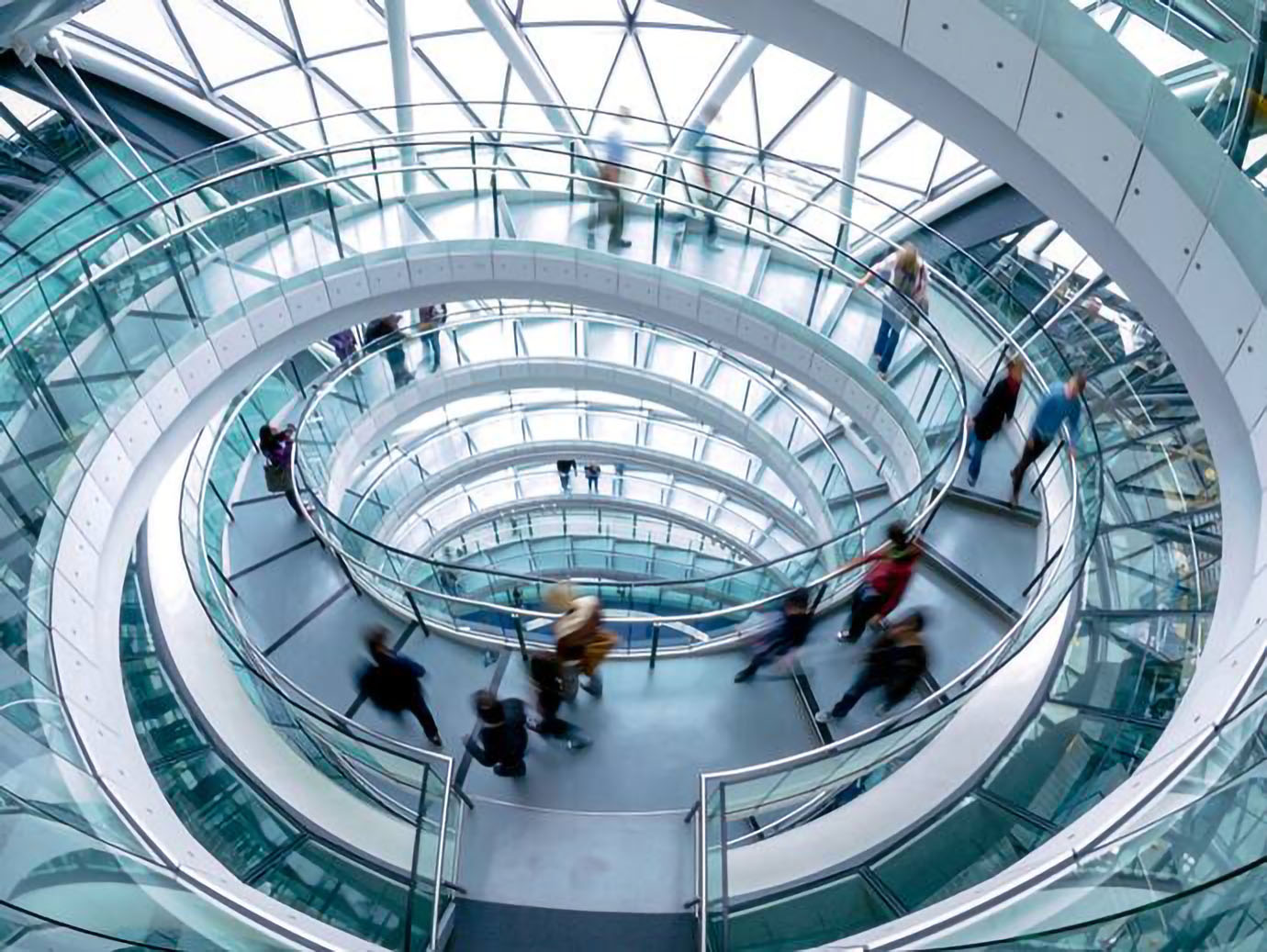 Motion blur image of people walking in a spiral staircase of a skyscraper