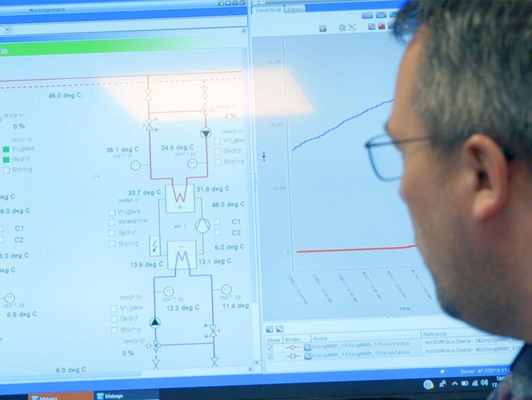 Close up of a person reading the metasys features on laptop