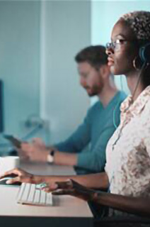 Group of employees working on their desktops in an office