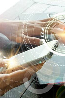 A person working on his laptop with an overlay of digital graphics