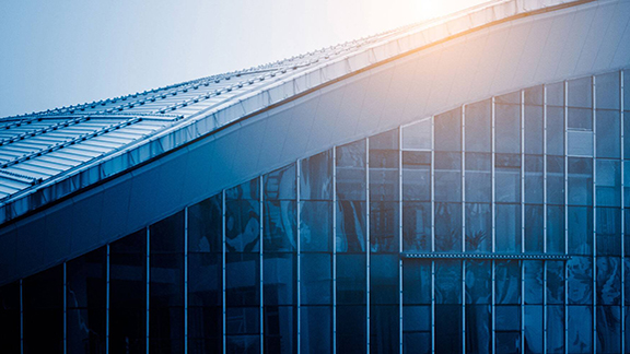 Modern building with glass exteriors with a blue gradient