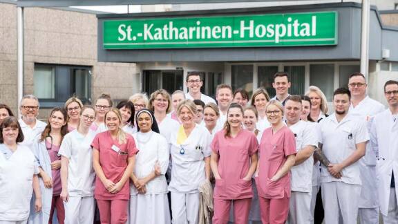 A group of nurses and doctors posing for a photograph