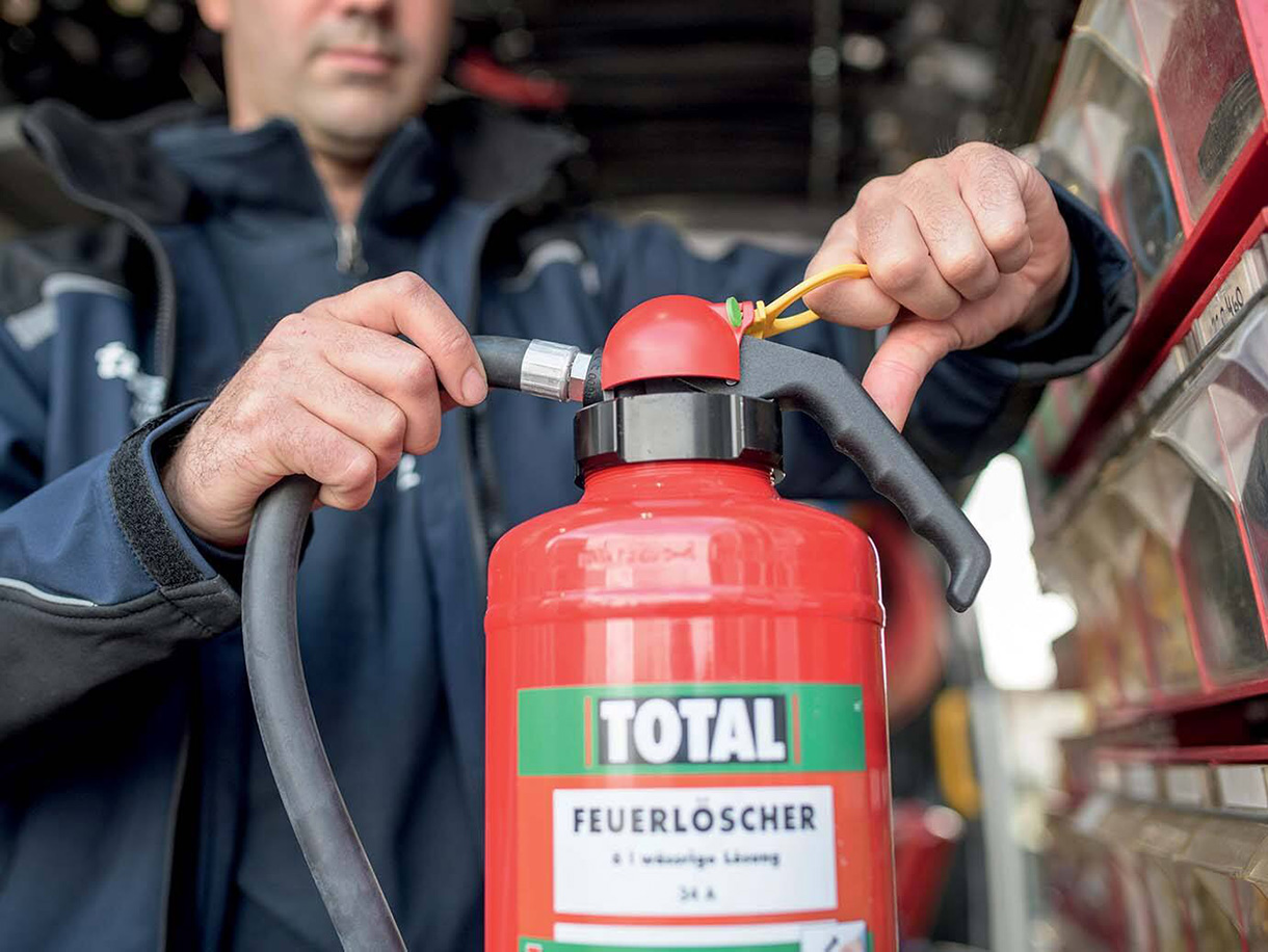 A firefighter operating a fire extinguisher