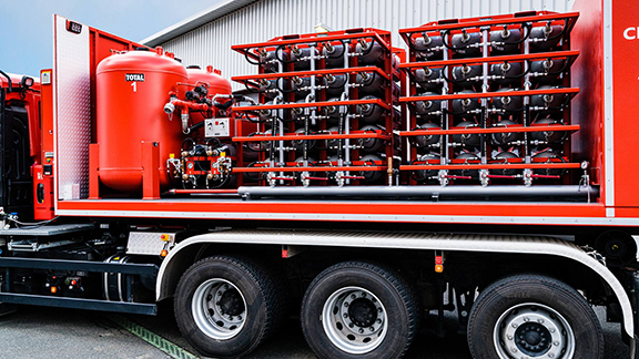A truck carrying rows of total fire extinguishers