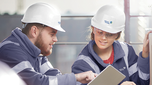 Two technicians looking at the tab