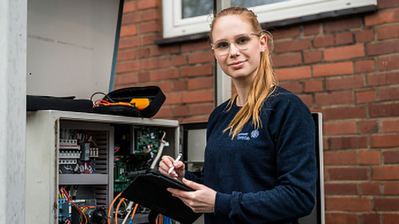 Woman checking the board and writing it on the note