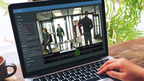 A man monitoring cctv footage on his laptop