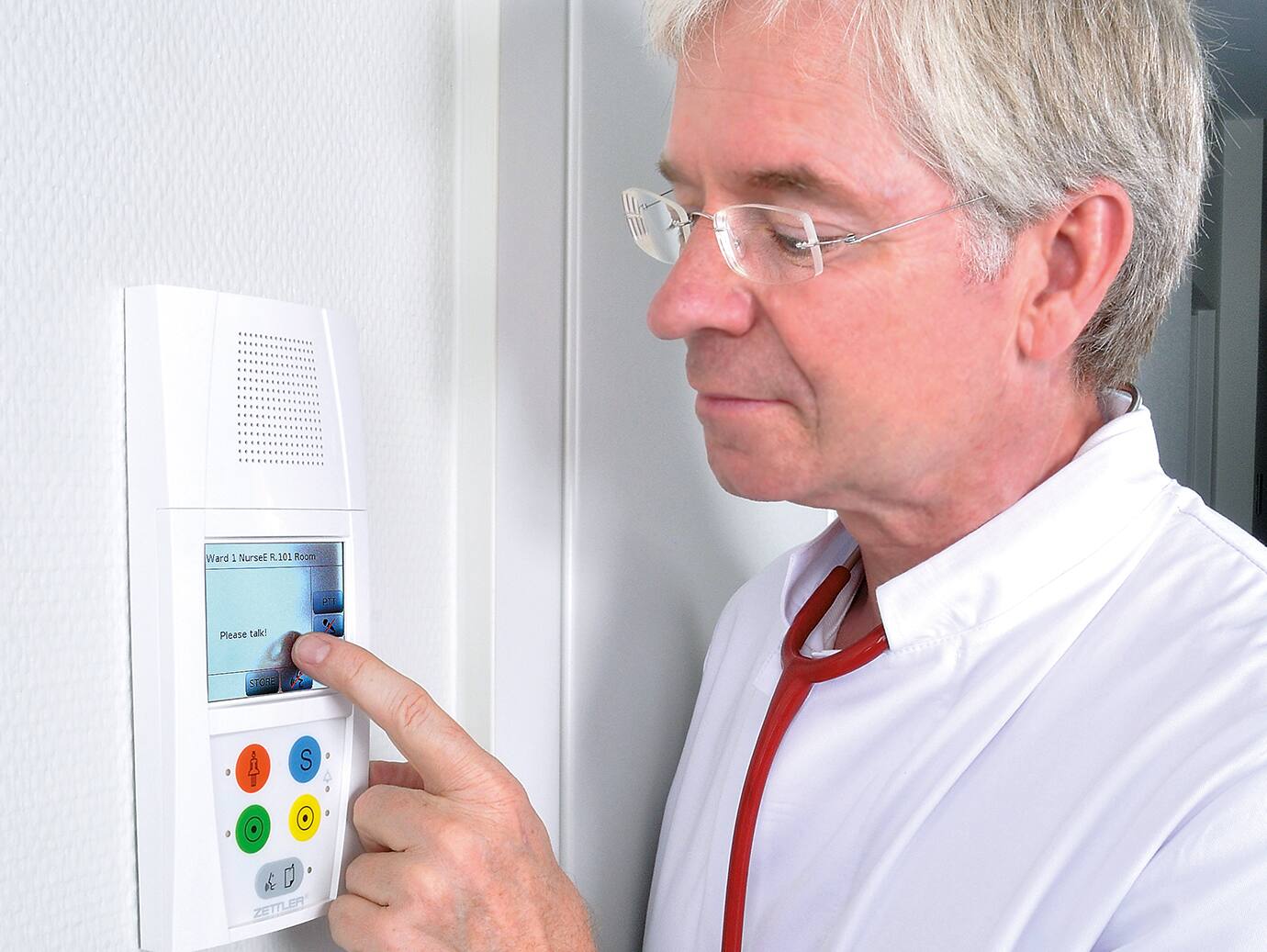 A doctor using a nurse call care device in a hospital