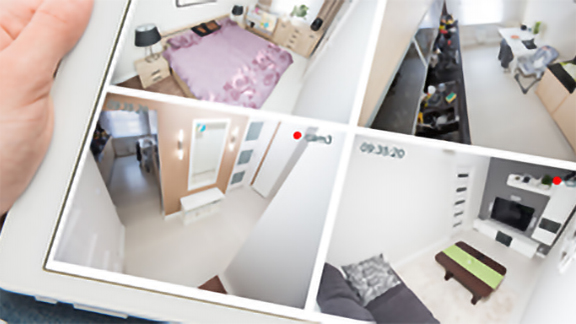 Man holding a tab with security camera app