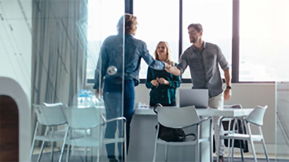 Group of people discussing and shaking hands