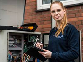 Working is looking at camera and smiling