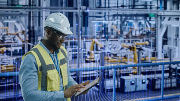 Johnson Controls technician using a tablet in a room with HVAC equipments