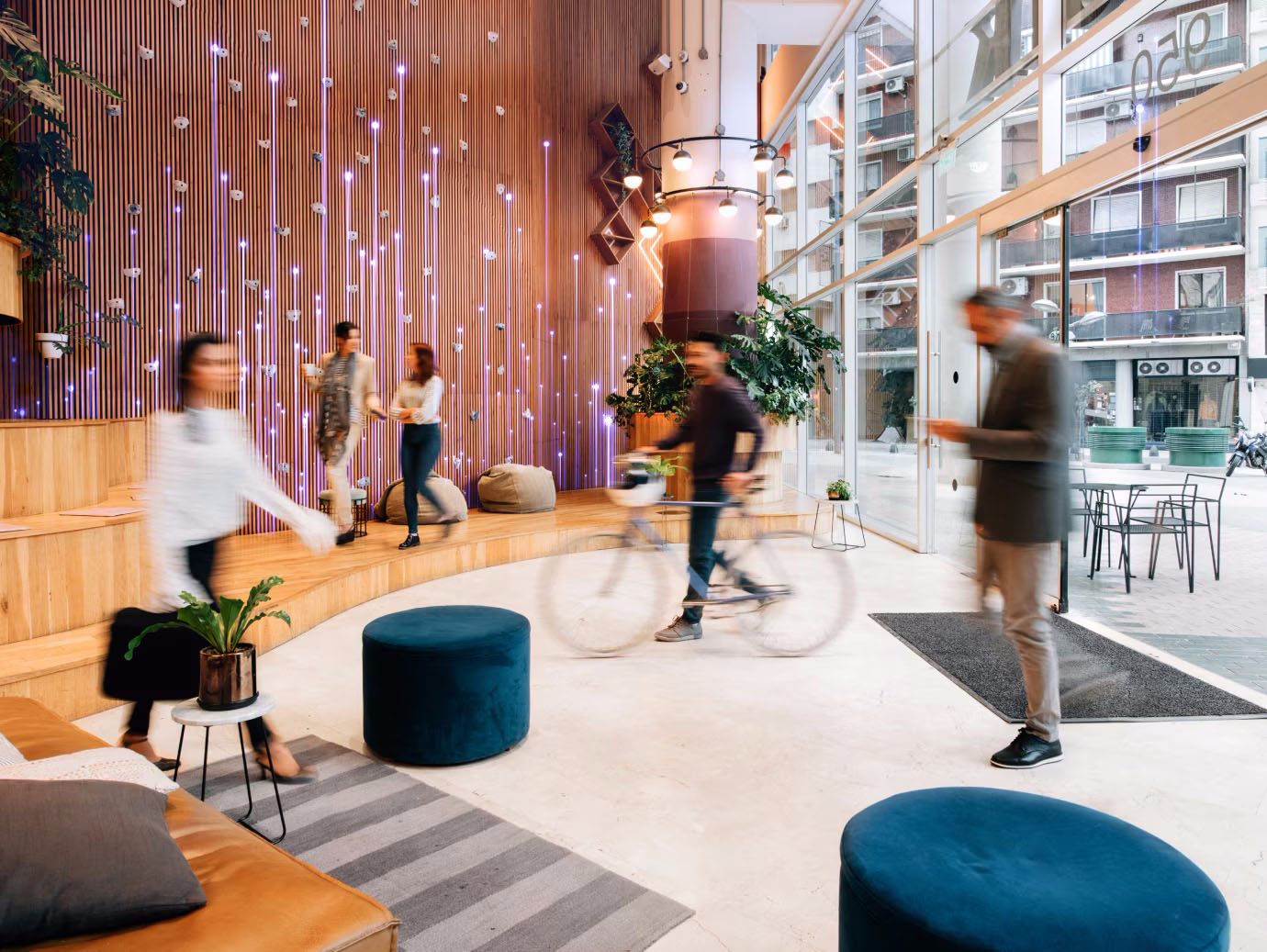 Motion blur shot of office employees walking in and out of the lobby