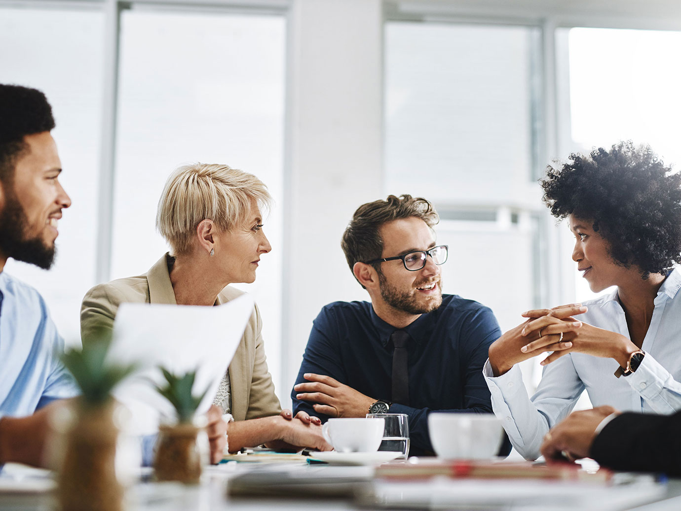 Diverse group of coworkers in conversation in a conference room