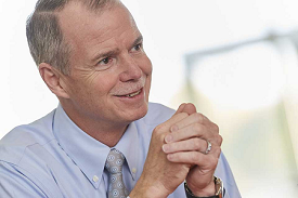 George R. Oliver, CEO of Johnson Controls, smiling