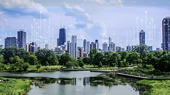 An urban skyline on the banks of a water body, with OpenBlue graphics in the background